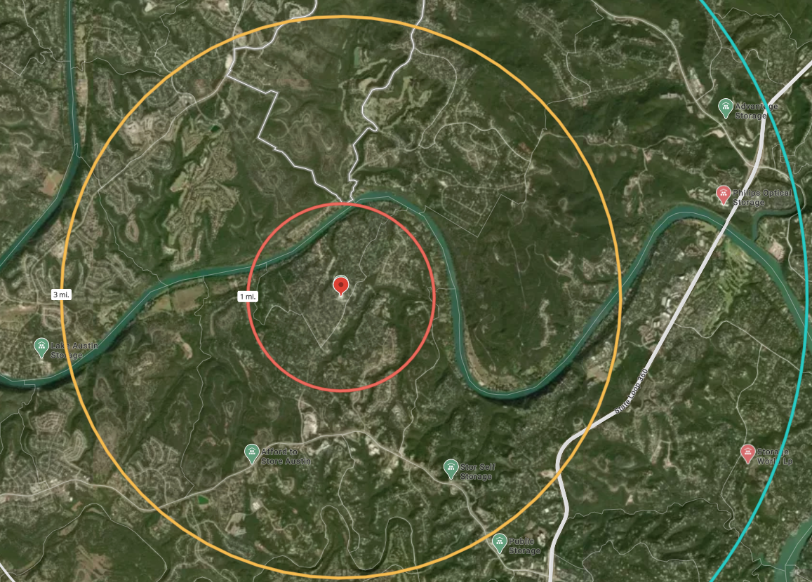Map showing self-storage property location with radius circles and nearby topographical barriers for site analysis 